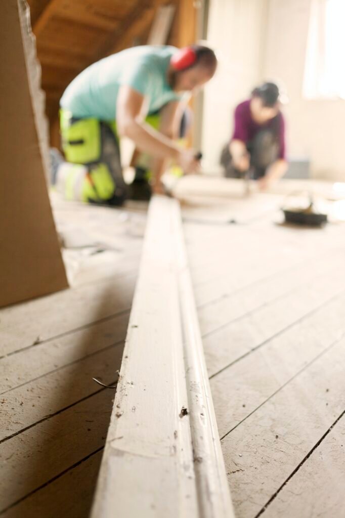 Couple working to renovate old attic